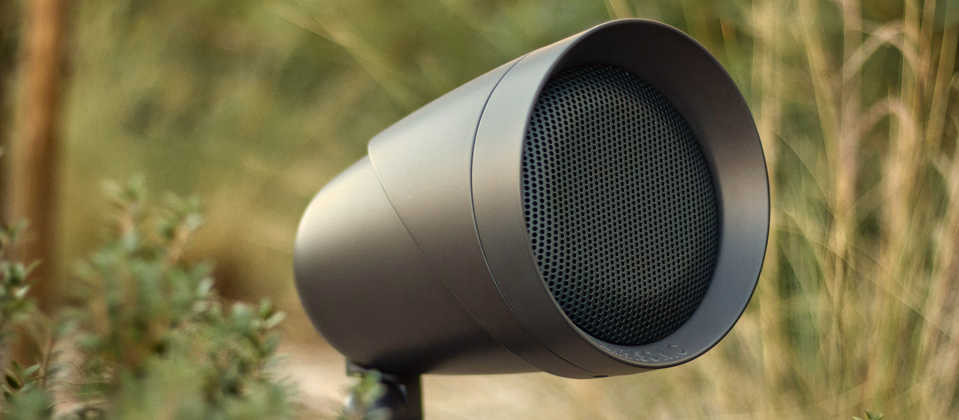 Outdoor landscape audio speaker installed in landscaping